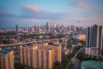 Aerial view of modern buildings in city against sky