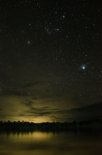 Scenic view of landscape against sky at night