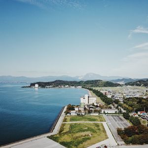 High angle view of sea and buildings against sky