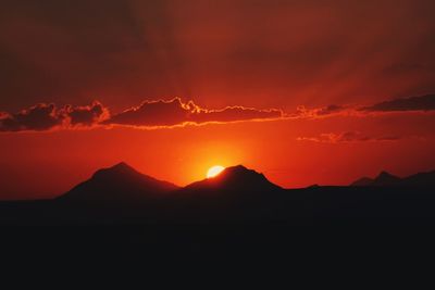 Scenic view of silhouette mountain against sky at night