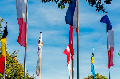 Various national flags on poles outdoors