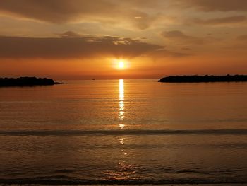 Scenic view of sea against romantic sky at sunset