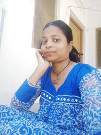Portrait of young woman at home