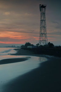 Silhouette tower against sky during sunset