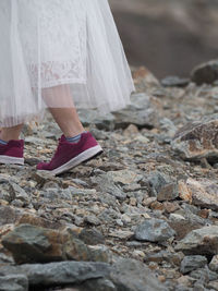 Low section of woman standing on rock