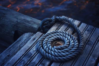 Close-up of rope on pier over sea