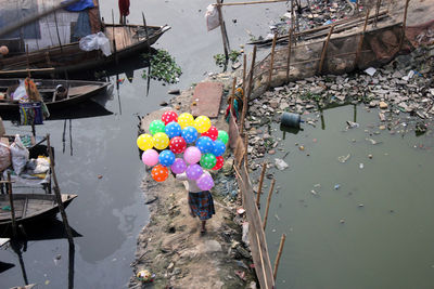 High angle view of multi colored boats and balloons in river