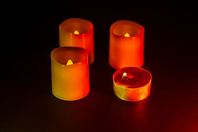 Close-up of illuminated candle against black background