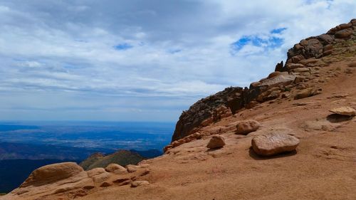 Scenic view of mountains against cloudy sky