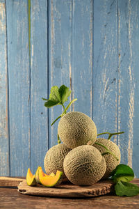 Close-up of fruits on table against blue background