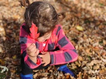 Full length of girl with autumn leaves