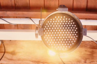 Close-up of electric lamp on table at home