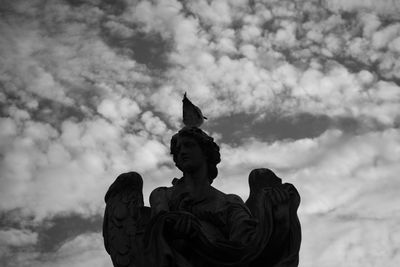 Low angle view of statue against sky