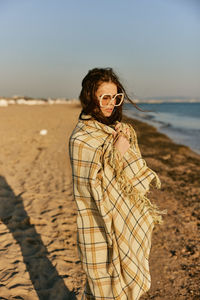 Young woman standing at beach