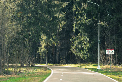 Road sign by trees