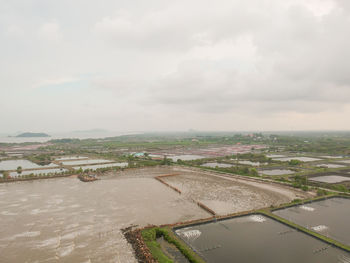 Aerial view of buildings in city against sky