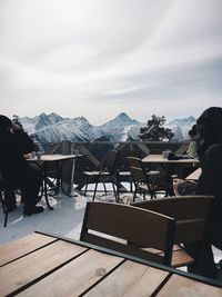 People at cafe against sky during winter