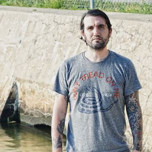 Portrait of young man standing against wall