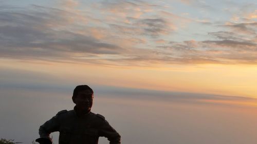 Full length of a man against sunset sky