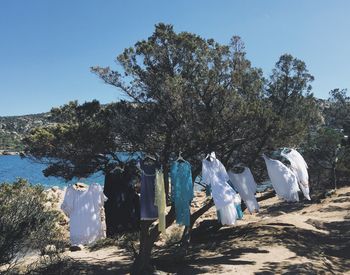 Clothes drying against clear blue sky