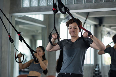 Young woman exercising in gym