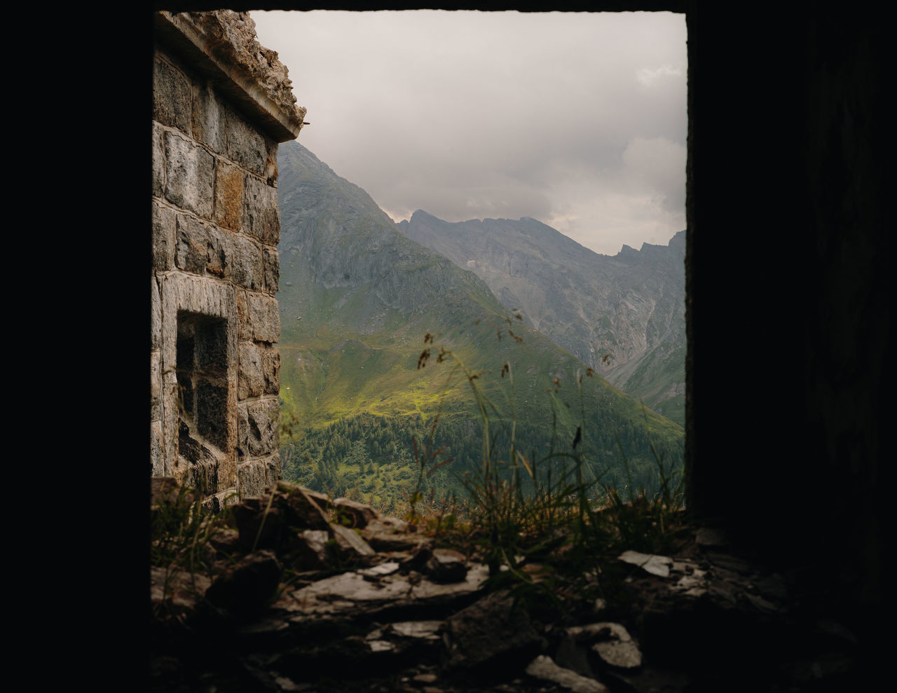 mountain, architecture, nature, darkness, sky, no people, landscape, scenics - nature, built structure, environment, land, building, mountain range, history, plant, outdoors, cloud, beauty in nature, rock, tranquility, the past, house, tree, building exterior, day, window, old, travel destinations, tranquil scene, travel