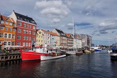 Boats in canal with buildings in background