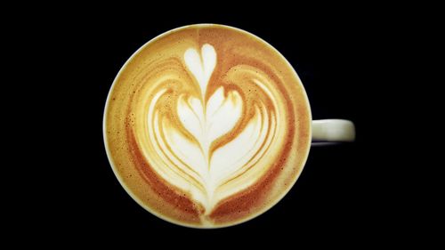 Close-up of cappuccino over black background