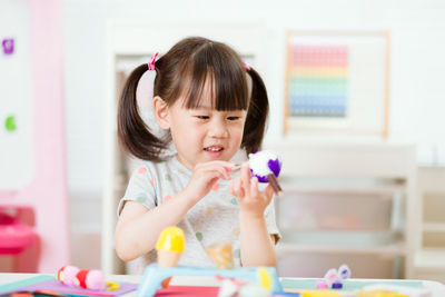 Young girl painting craft at home