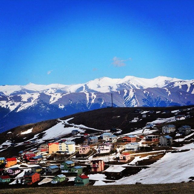 snow, winter, cold temperature, mountain, season, snowcapped mountain, weather, mountain range, clear sky, building exterior, blue, covering, architecture, built structure, copy space, scenics, transportation, snowcapped, beauty in nature, house