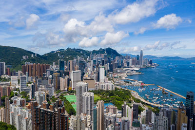 High angle view of city by sea against sky