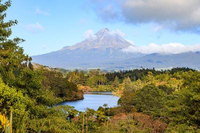 Scenic view of lake and mountains against sky