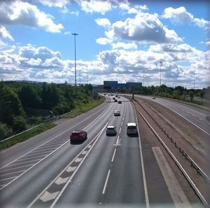 Cars on highway against sky