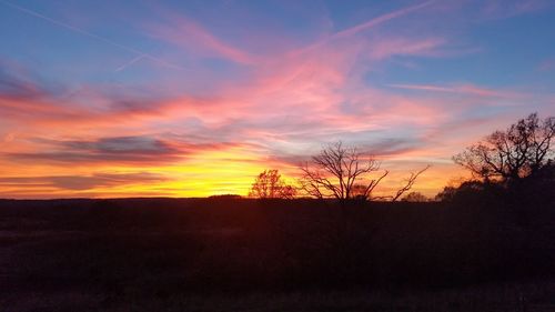 Scenic view of silhouette landscape against sky at sunset