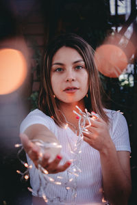 Portrait of a young woman drinking glass