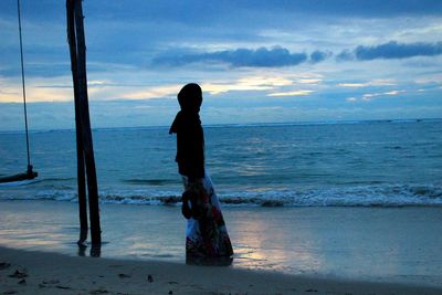 Man standing on beach against sky