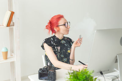 Young woman using mobile phone at home