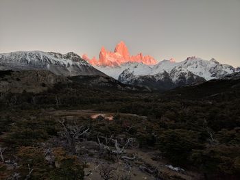 Scenic view of snowcapped mountains against sky during sunset