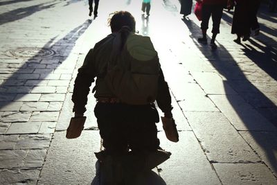 Woman standing on footpath