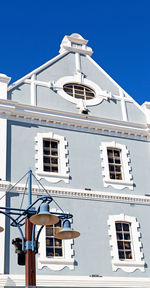 Low angle view of building against blue sky