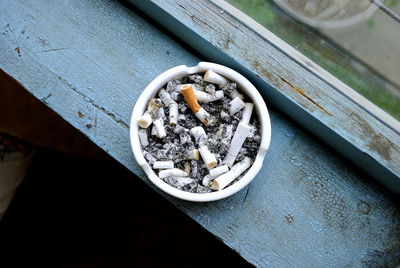 High angle view of ashtray on window sill