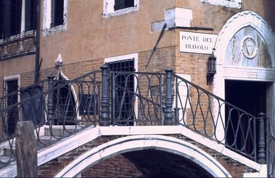 Low angle view of arch bridge against buildings