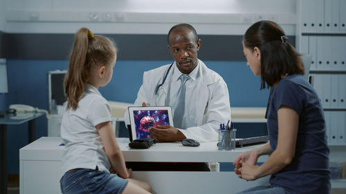 Female doctor examining patient at clinic