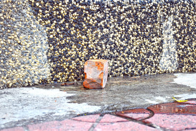 Close-up of rusty metal on footpath