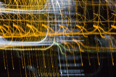 Full frame shot of illuminated light trails at night