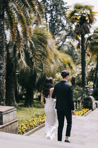 Rear view of couple walking in park