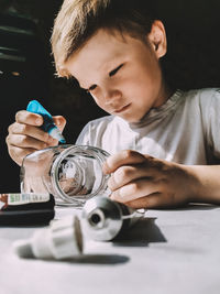 Portrait of boy holding table