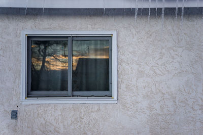 Close-up of window on wall during winter