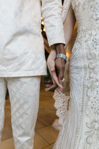 Rear view of couple holding hands