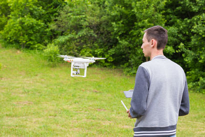 Rear view of man standing by airplane